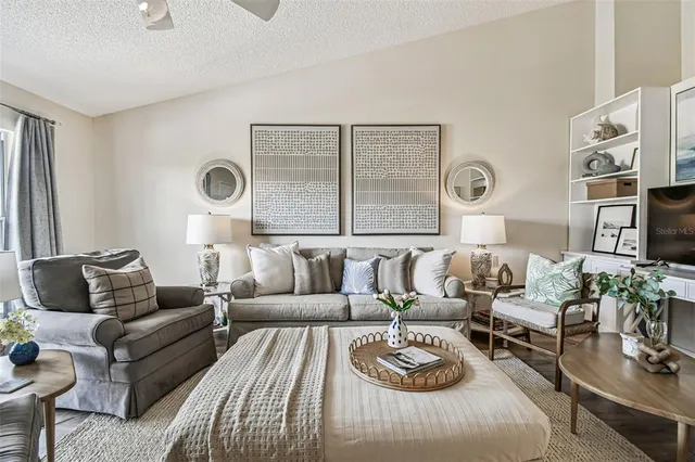 a living room with furniture a clock and a window