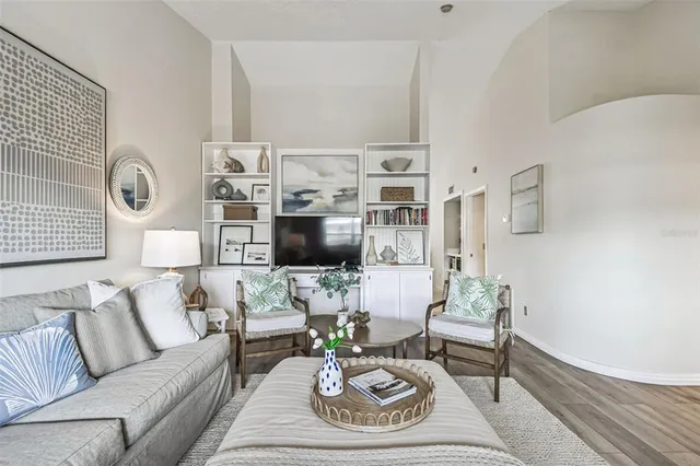 a living room with furniture a rug and a flat screen tv