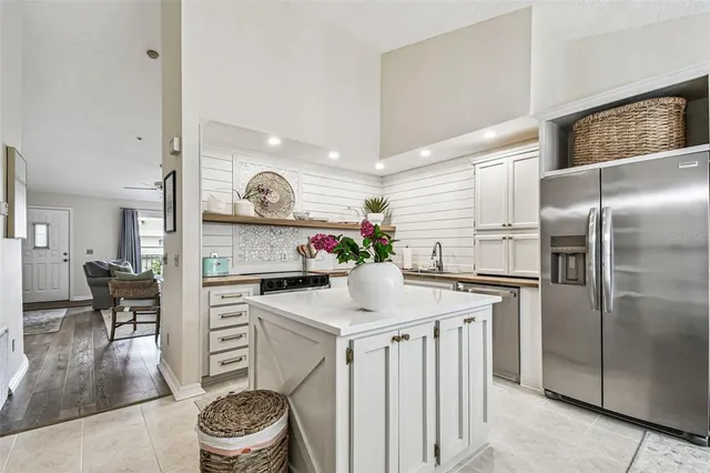 a kitchen with granite countertop a sink stove and refrigerator