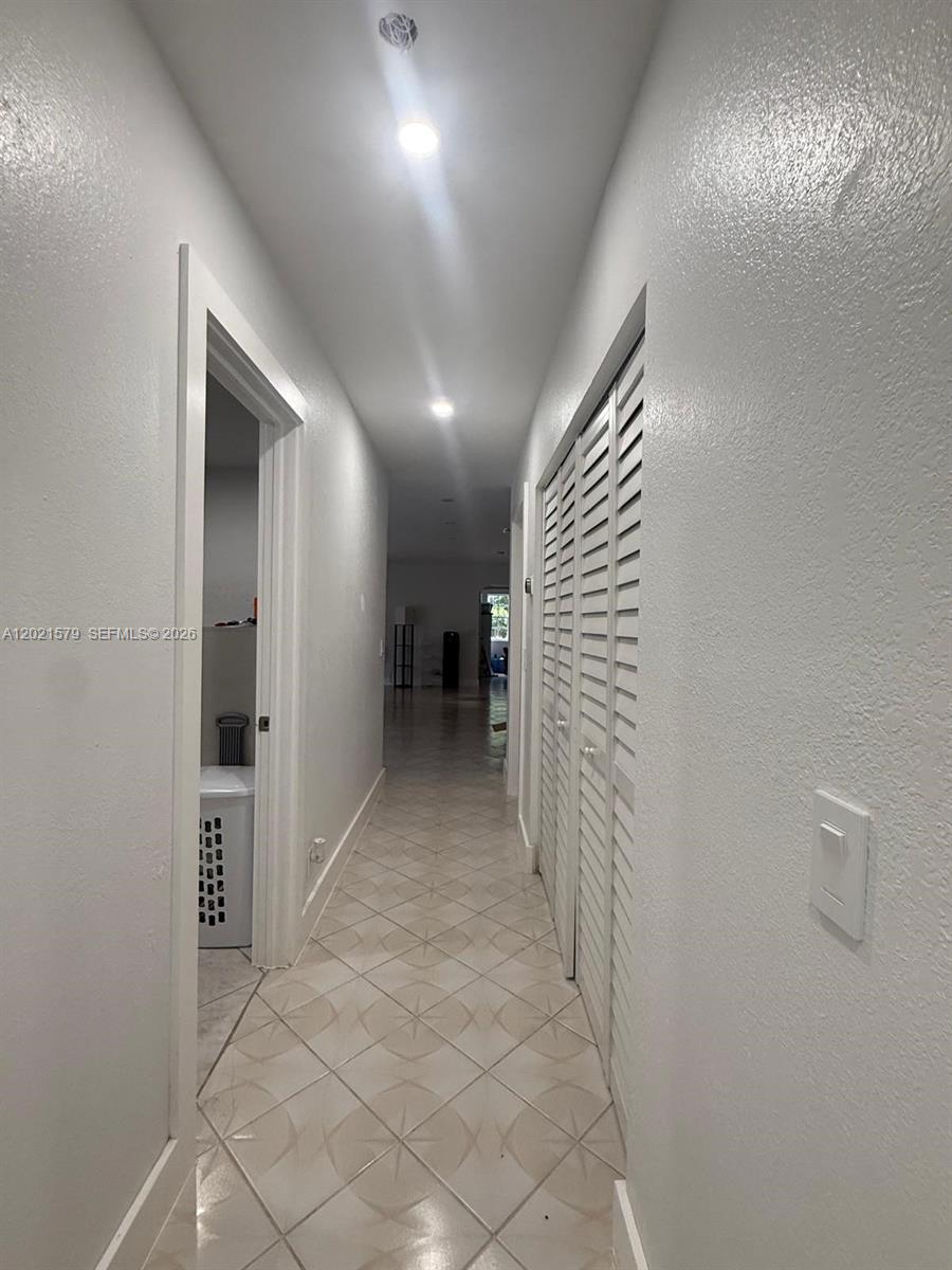 22445 Southwest 264th Street Homestead, FL 33031 - Photo 5 of 12 a view of livingroom with hallway and stairs