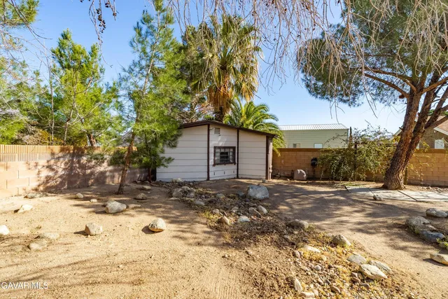 a backyard of a house with large trees