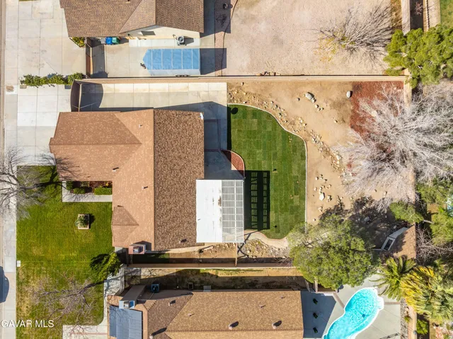 an aerial view of a house with a yard