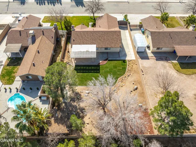 an aerial view of a house with a yard and sitting area