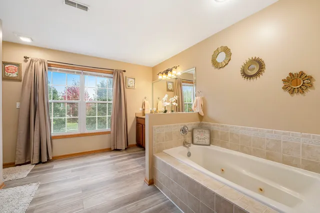 a bathroom with a bathtub and a window
