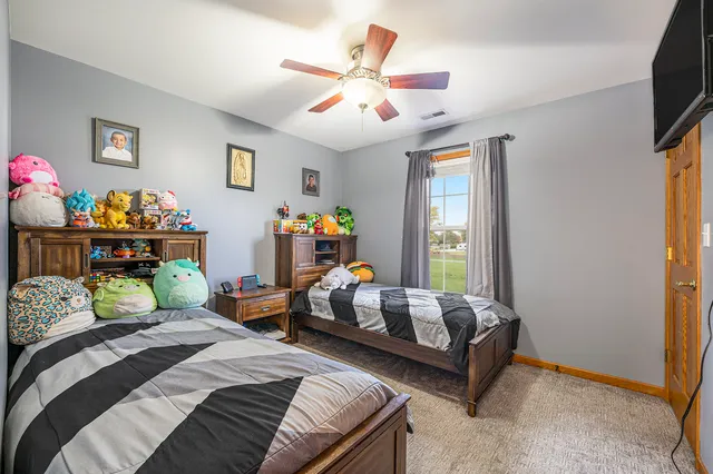 a bedroom with bed and a window