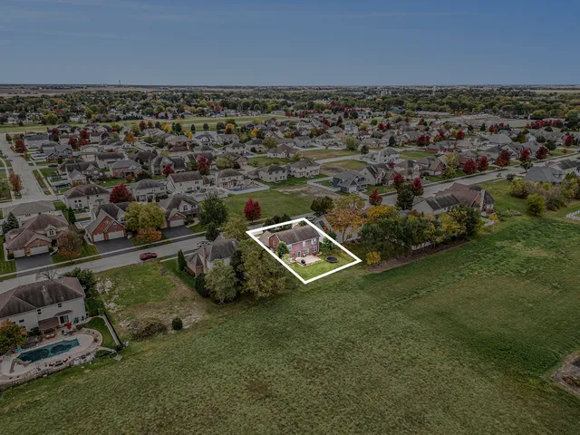 an aerial view of a residential houses with outdoor space