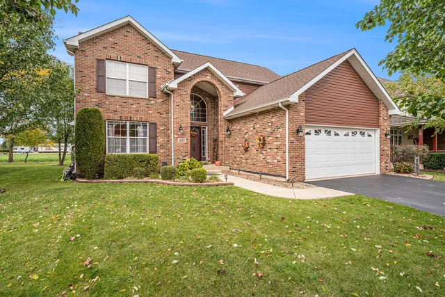 a front view of a house with a yard and garage
