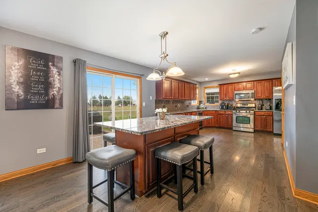 a dining room with furniture and wooden floor