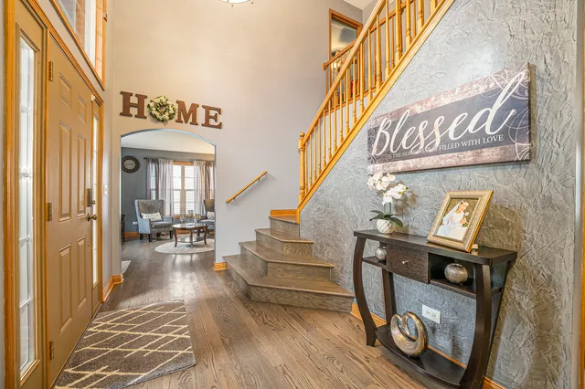 a view of entryway and hall with wooden floor