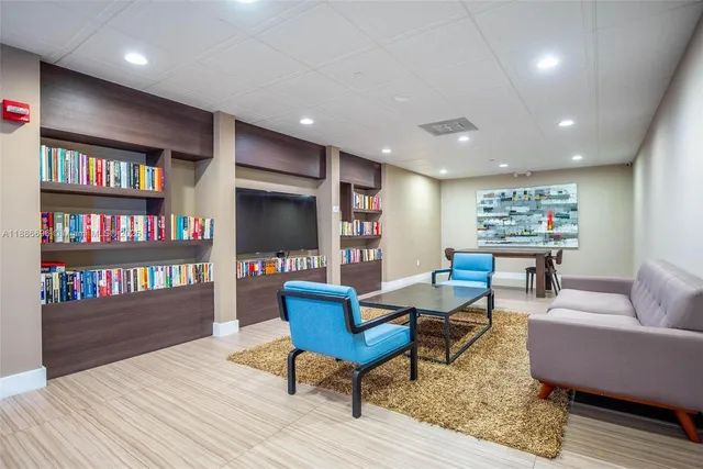 a living room with furniture and a book shelf