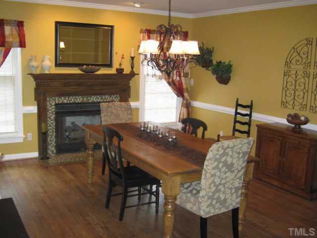 This room is currently being used as the dining room, but can be switched back to use as the family room. Fireplace has mosaic tile surround with a lovely wood mantle, with windows on either side, framing the fireplace nicely & letting in natural light!