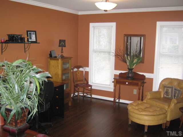 This lovely room is currently being used as a home office and relaxful reading area. Crown molding and chairrail details are featured along with newly refinished hardwood floors!