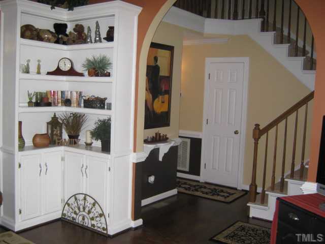 Nice built-ins in the living room add a wonderful touch, view towards the entry foyer, nice archway details accent some of the architechtural details of this lovely home, newly refinished hardwoods.
