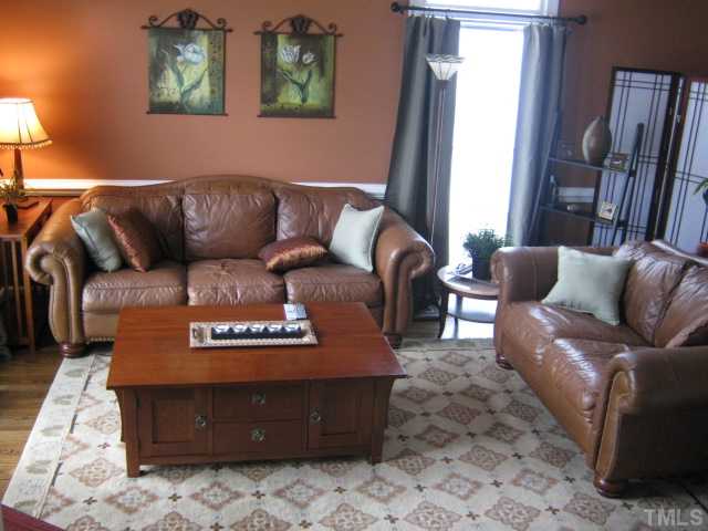 Lovely living room features a vaulted ceiling, great built-ins, newly refinished hardwood floors, flows toward the foyer and staircase thru the archway and then in the other direction flows towards the dining room (being used as office/reading room)