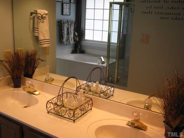 9117 Doublebit Drive Raleigh, NC 27615 - Photo 8 of 12 Master bath features a jetted garden tub, separate shower, water closet, skylight, has a walk-in closet, and a dual sink vanity with plenty of storage under sinks and in drawers.