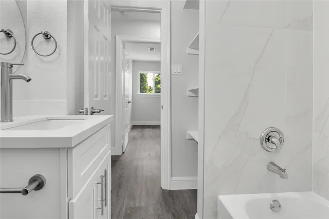 a bathroom with a sink a mirror and a shower