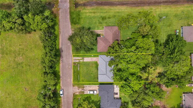 an aerial view of a house with a yard