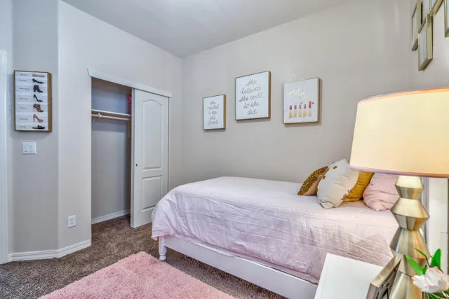 a bedroom with a bed and lamp