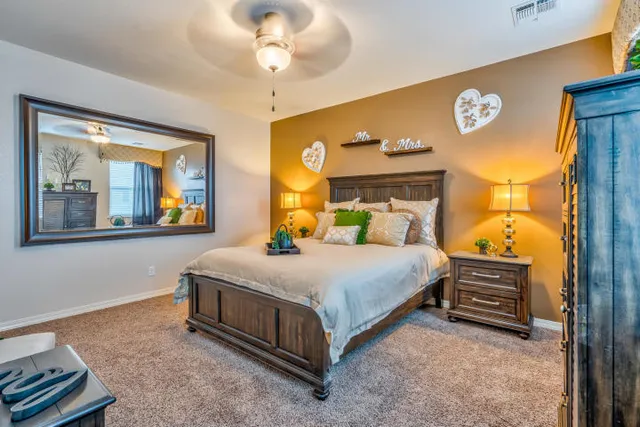 a bedroom with a bed and a chandelier