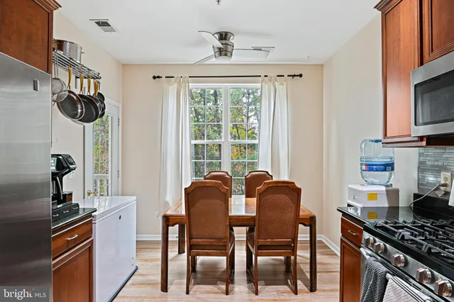 a view of a dining room with furniture and a window