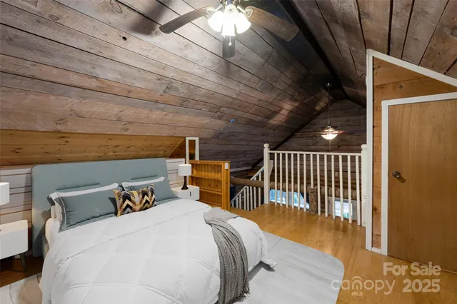 a bed sitting in a bedroom next to a window