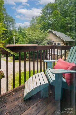 a view of a wooden chairs and table in the balcony
