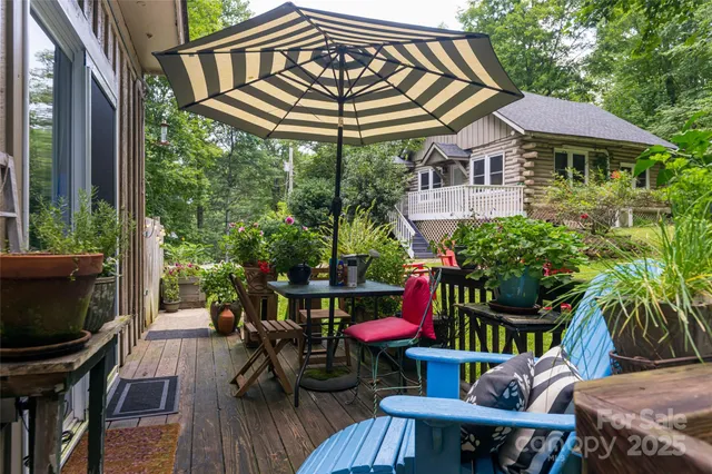a view of a patio with table and chairs potted plants with wooden floor