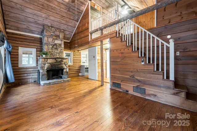 a view of a livingroom with wooden floor and stairs