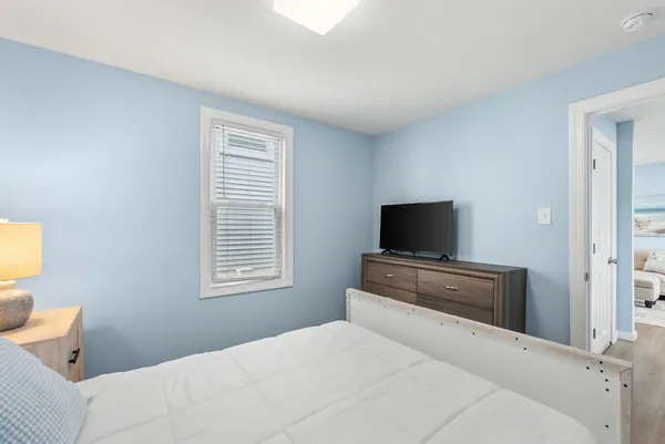 a bedroom with a bed and a television