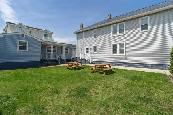 a backyard of a house with table and chairs