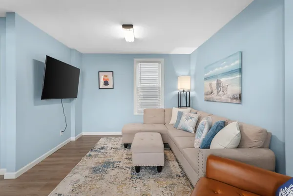 a living room with furniture and a flat screen tv
