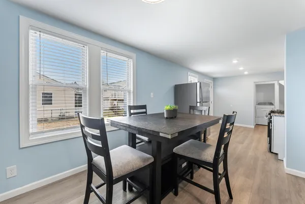 a view of a dining room with a table and chairs