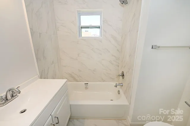 a bathroom with a bathtub and sink