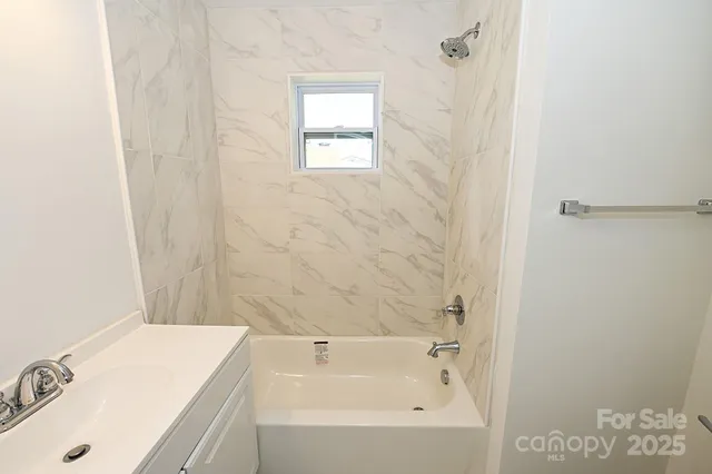 a bathroom with a bathtub and shower