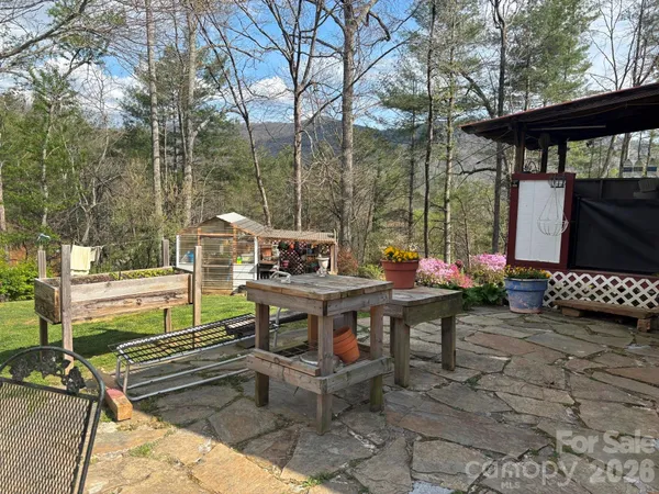 a view of backyard with outdoor seating and trees