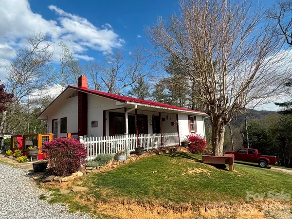 a front view of house with yard and swimming pool