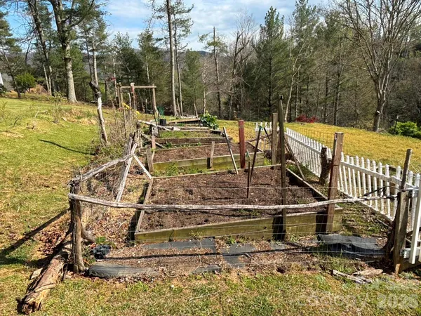 a view of a swimming pool with a patio and wooden fence