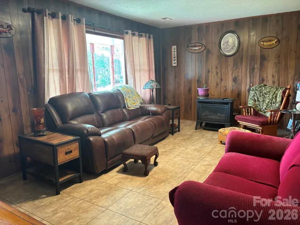 a living room with furniture a clock and a window