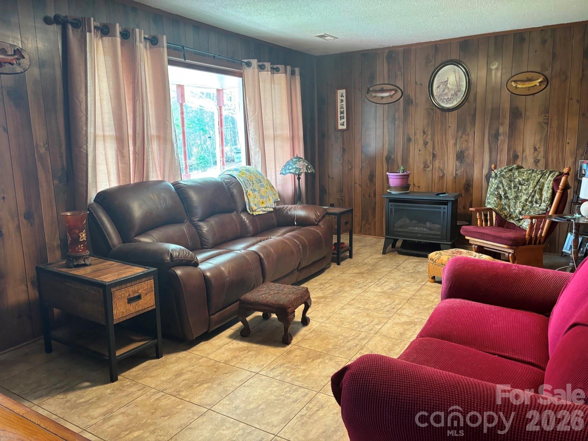 493 Franklintown Road Spruce Pine, NC 28777 - Photo 5 of 27 a living room with furniture a clock and a window