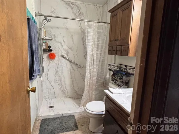 a bathroom with a sink toilet and shower