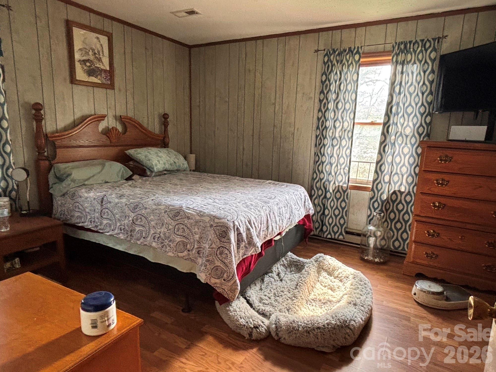 493 Franklintown Road Spruce Pine, NC 28777 - Photo 7 of 27 a bedroom with a bed and a television