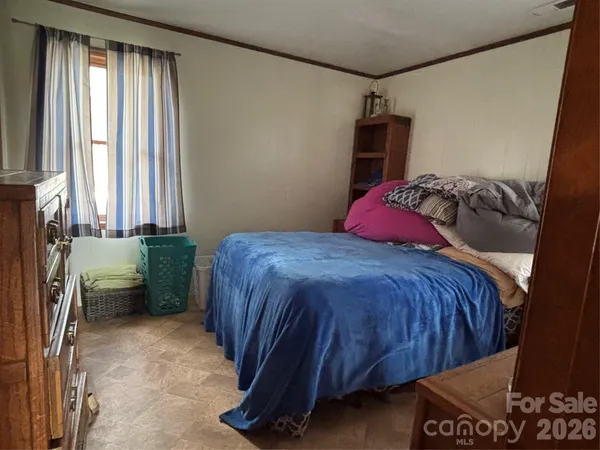 a bedroom with a bed and a window