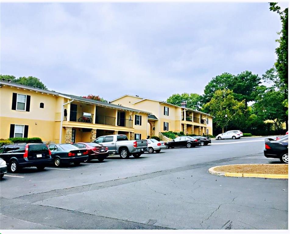 1150 Collier Road Northwest, Unit A1 Atlanta, GA 30318 - Photo 1 of 1 a front view of a building with cars parked