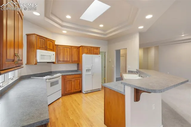 a kitchen with kitchen island a sink stove and refrigerator