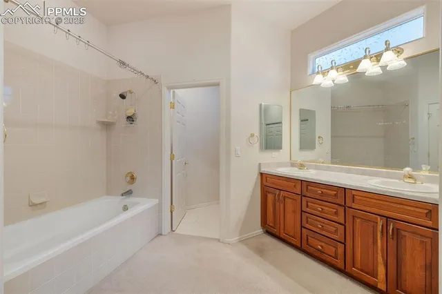 a spacious bathroom with a tub sink shower and mirror