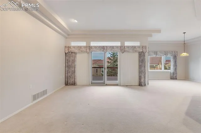 a view of a room with a refrigerator and a sink