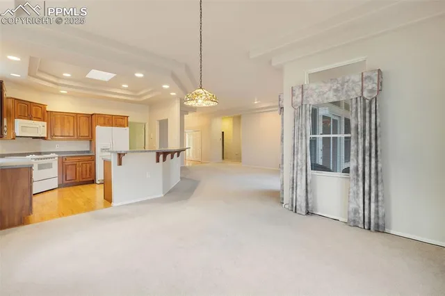 a view of a kitchen with a refrigerator a microwave and a sink