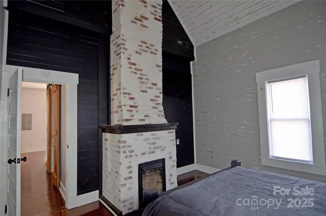 a view of an empty room with a fireplace