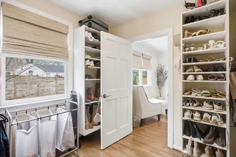 a large bathroom with a double vanity sink a large mirror and a shower