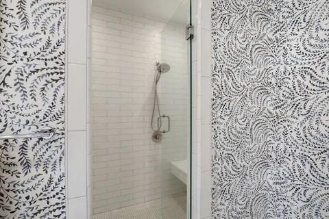 a living room with furniture a flat screen tv and a window